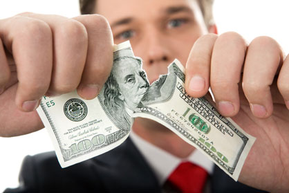 Man ripping a dollar bill.